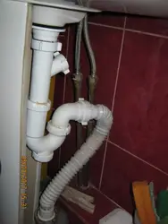 Pipe under the sink in the kitchen photo