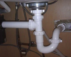 Pipe under the sink in the kitchen photo
