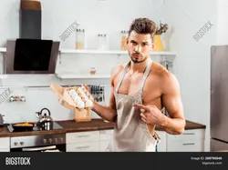 Men in an apron in the kitchen photo