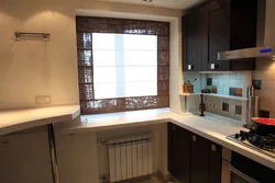 Wide window sill in the kitchen design