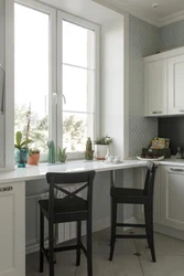 Wide window sill in the kitchen design