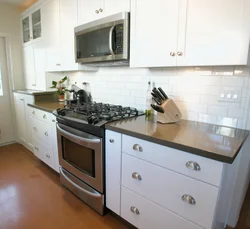 Kitchen with a regular stove photo