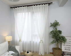 White tulle in the living room interior