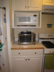 Microwave in the kitchen on the window photo