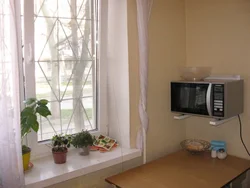Microwave in the kitchen on the window photo