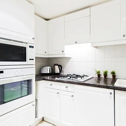 White kitchen with black stove photo