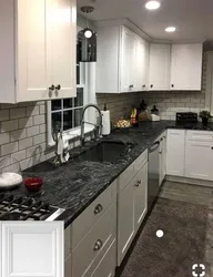 White kitchen with black stove photo