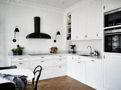 White kitchen with black stove photo