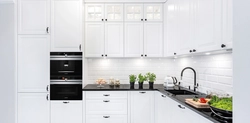 White Kitchen With Black Stove Photo