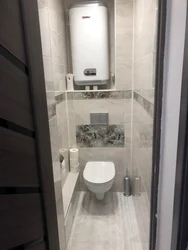 Photo of a toilet in an apartment with a boiler