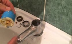 Photo of a disassembled faucet with bathtub