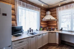 Kitchen in a wooden house with a sink by the window photo