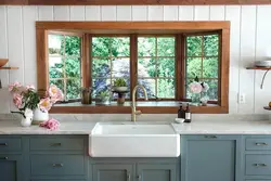 Kitchen in a wooden house with a sink by the window photo