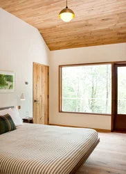 Bedroom Design In A House With A Wooden Ceiling