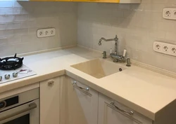 Small kitchen design photo sink in the corner