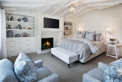 Дизайн спальни с диваном и камином