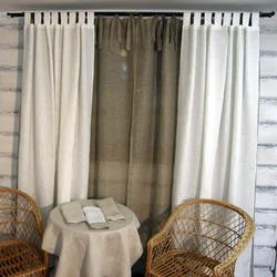 Tulle under linen in the living room interior