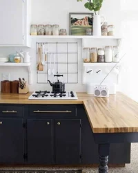 Black and white kitchen with wooden countertop photo