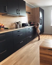 Black and white kitchen with wooden countertop photo