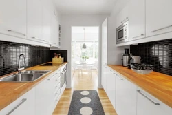 Black and white kitchen with wooden countertop photo