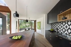 Black and white kitchen with wooden countertop photo
