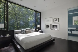 Photo of a bedroom in a house with one window in a modern style