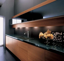 Wood kitchen with black countertop photo