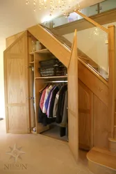 Dressing room under the stairs in the house photo