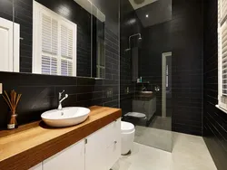 Bathroom design with dark tiles and wood