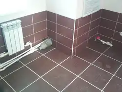 Laying tiles in an apartment photo