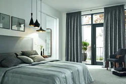 Curtains in a gray and white bedroom interior