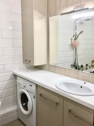 Bath design with a cabinet for a washing machine