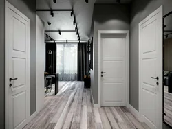 Интерьер квартиры с темным полом и белыми дверями