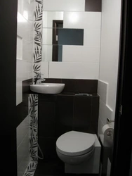 Interior of a small toilet in an apartment separate from the bathtub in a panel