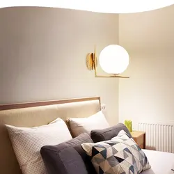 Sconce on the wall in the bedroom above the bed photo