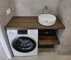Bathroom cabinet with sink and washing machine photo
