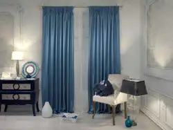 Curtains in the bedroom interior with blue wallpaper