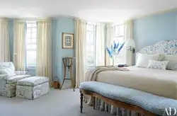 Curtains in the bedroom interior with blue wallpaper