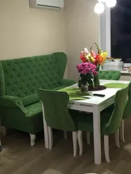 Photo of a kitchen with a sofa and table chairs