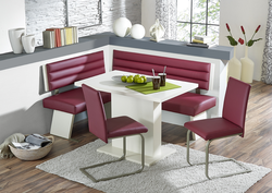 Photo of a kitchen with a sofa and table chairs