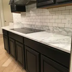 Kitchen design with marble countertops and splashback