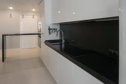 Ошхона бо пешдомани сиёҳ ва countertop дар дохили сафед