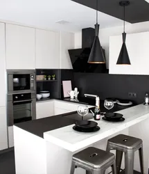 Kitchen with a black apron and countertop in a white interior