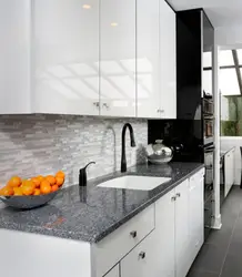 Kitchen With A Black Apron And Countertop In A White Interior
