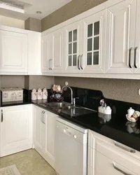 Kitchen With A Black Apron And Countertop In A White Interior