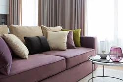 Gray sofa with pillows in the living room interior