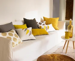 Gray sofa with pillows in the living room interior