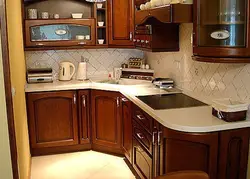 Corner kitchens with a sink in the corner and a refrigerator photo