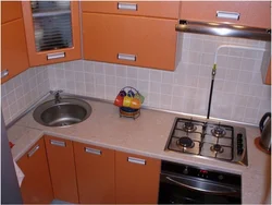 Corner kitchens with a sink in the corner and a refrigerator photo