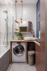 Interior Of A Small Bath With Sink And Washing Machine